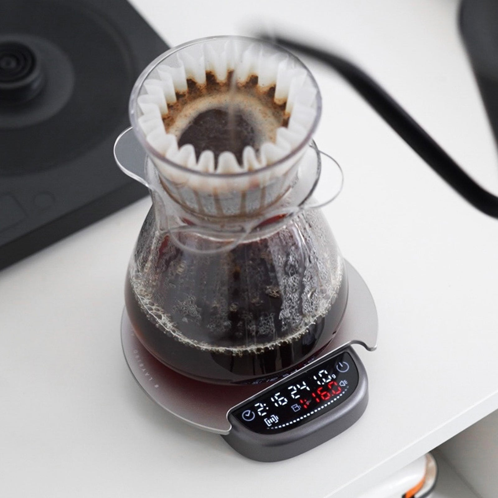 Pour-over brewer and coffee server on a coffee scale with an extension platform