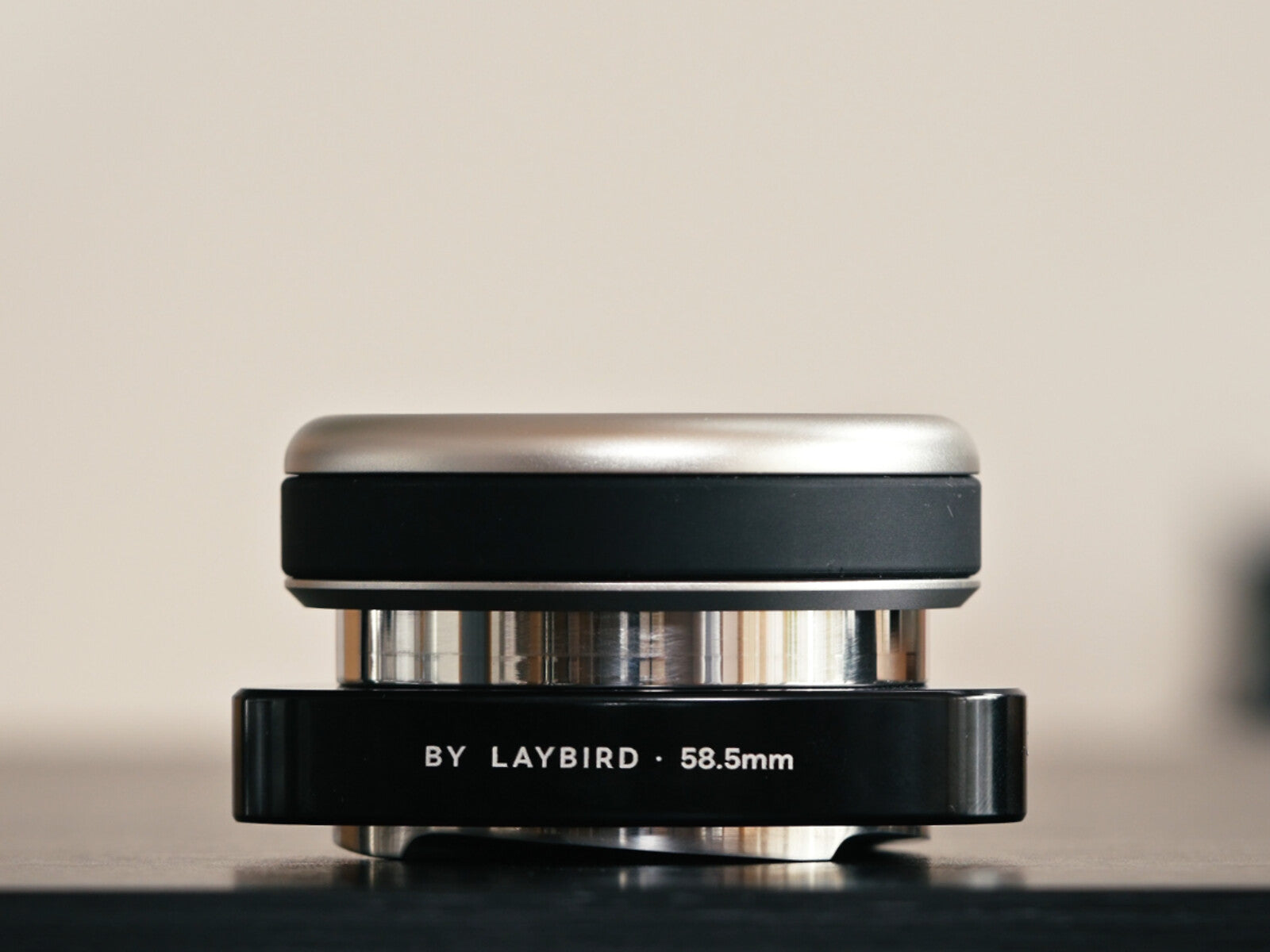 Side view of the 58.5mm LAYBIRD TriSpin coffee distributor showing its layered construction